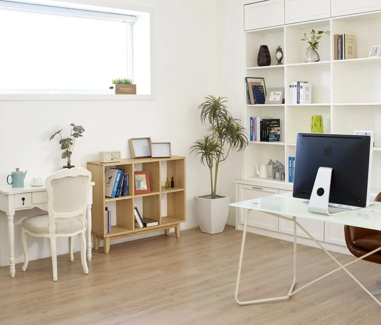 Covered with sheet sofa and floor lamp and packed cardboard boxes in light spacious room of new contemporary house